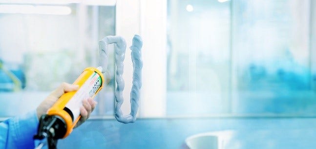 A close-up of Sunstar adhesive solution being used on a glass ceiling.
