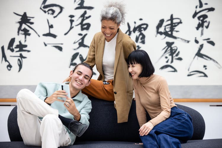 People-sitting-on-couch-checking-phone