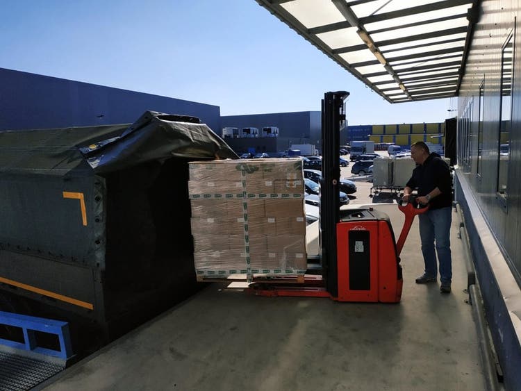 man loading boxes to a truck